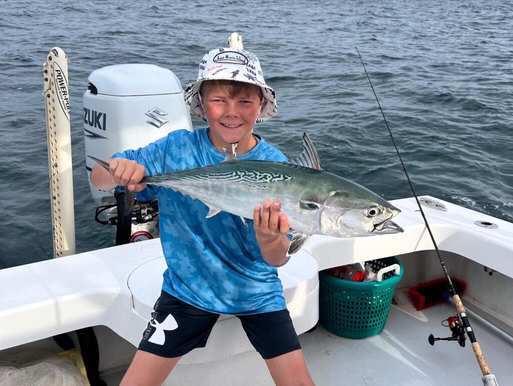Near Fishing Bonito Held By Kid Client